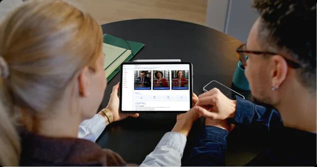 Two people reviewing their Warren dashboard together on a tablet